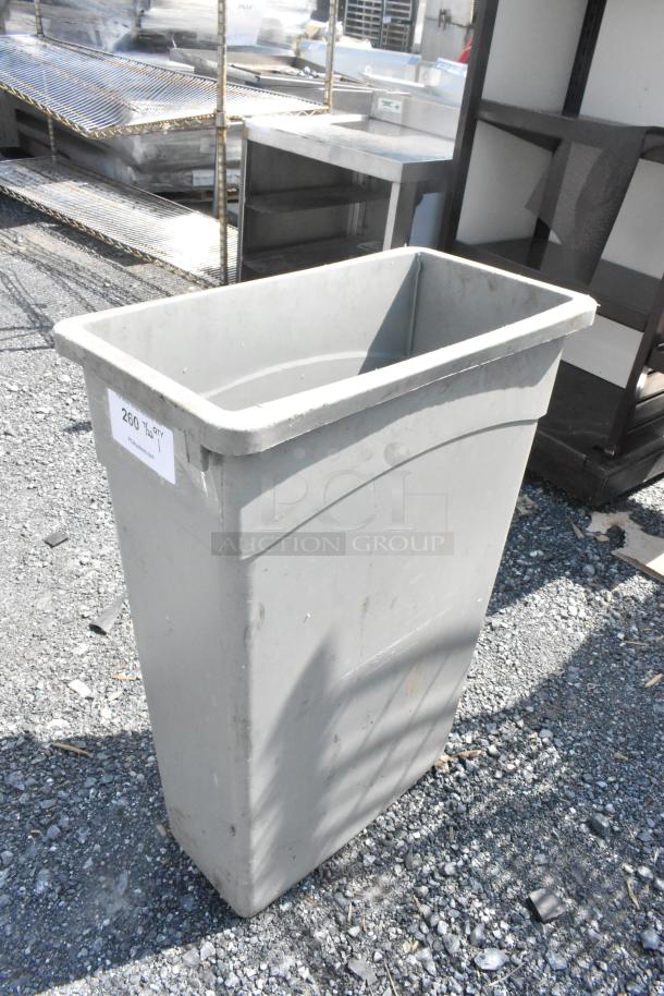 Gray Poly Slim Jim trash can, rectangular, used condition, visible label "260 QTY 1," suitable for commercial use.