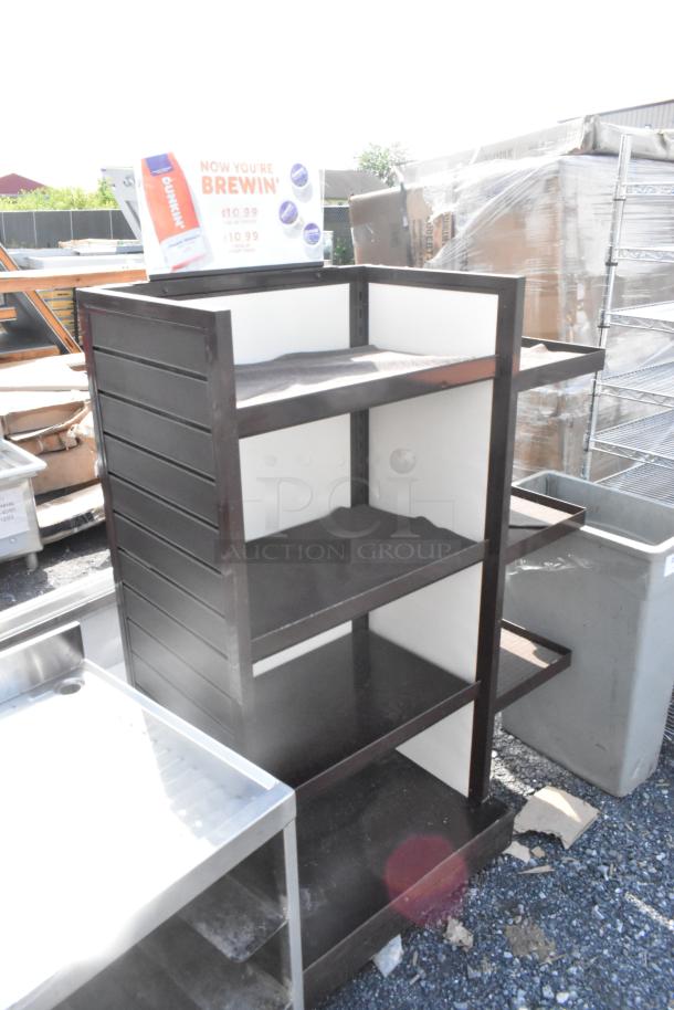 Brown metal shelving unit with three shelves, visible sign on top. Good condition, suitable for storage or display.