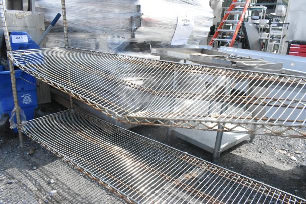 Chrome finish 4-tier wire shelving unit with signs of rust, requiring dismantling by buyer. Consider freight charges.