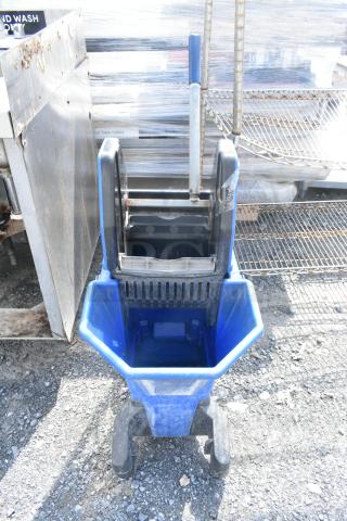 Blue poly mop bucket on casters with wringer, good condition, sturdy design, suitable for commercial cleaning.