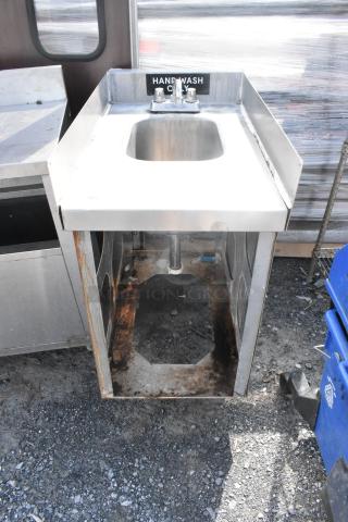 Stainless steel single bay sink with faucet and handles, labeled "HAND WASH ONLY", visible rust and wear on base.