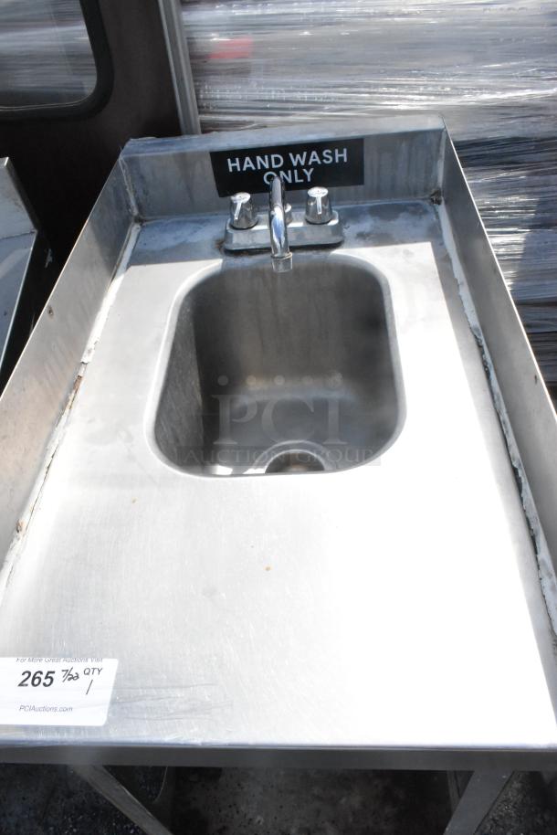 Stainless steel single bay sink with faucet and handles, labeled "Hand Wash Only," in used condition. Auction tag visible.
