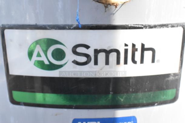 AO Smith BTR-120118 natural gas water heater, 120,000 BTU, metal casing, visible brand logo, good condition for auction.