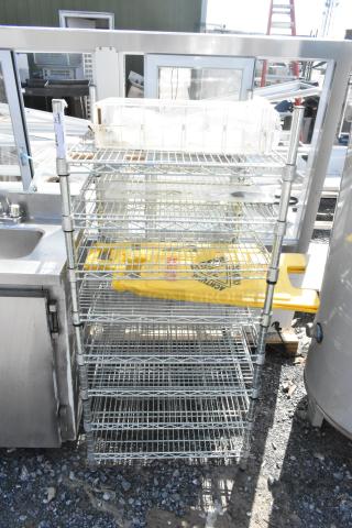 Chrome finish 8-tier wire shelving unit with contents, including wet floor signs. Buyer must dismantle for shipping.