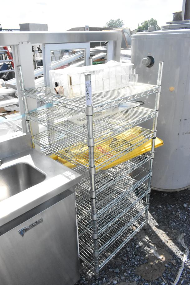 Chrome finish 8-tier wire shelving unit with wet floor signs. Buyer must dismantle. Consider freight charges.