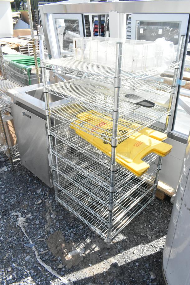 Chrome finish 8-tier wire shelving unit with contents, including wet floor signs. Buyer to dismantle; consider freight charges.