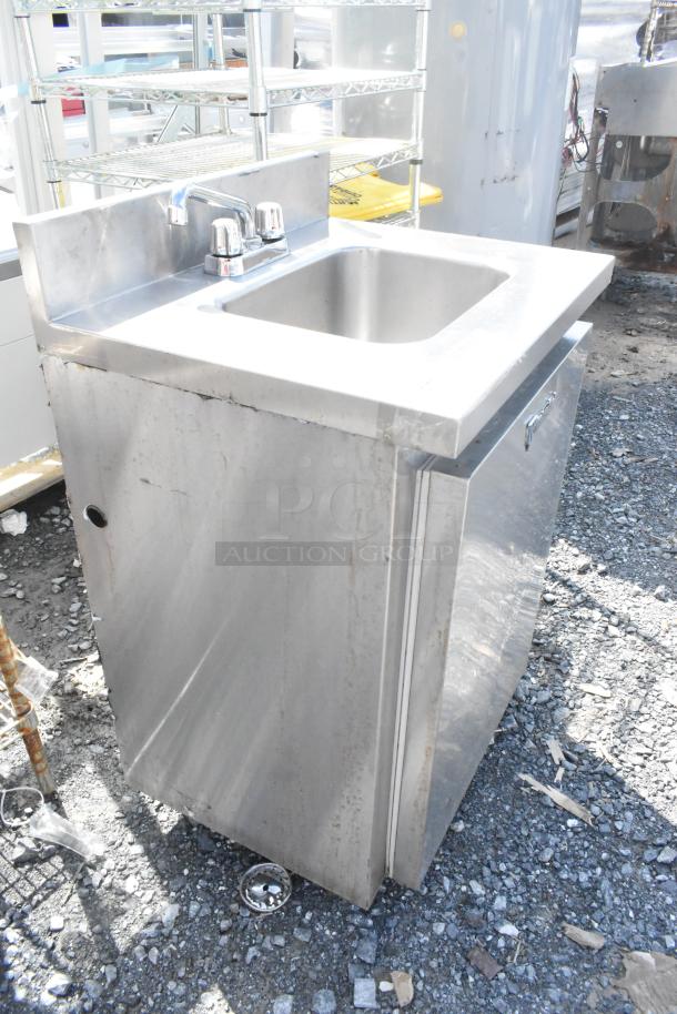 CustomCool stainless steel commercial single bay sink with faucet and handles. Slight wear visible on the cabinet.