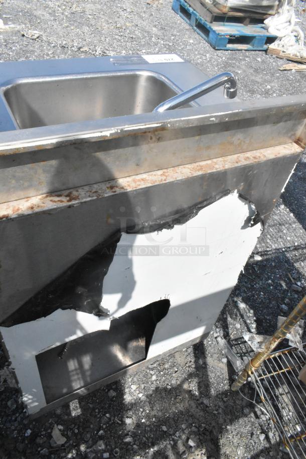 CustomCool stainless steel commercial single bay sink with faucet and handles, showing wear and corrosion on the surface.
