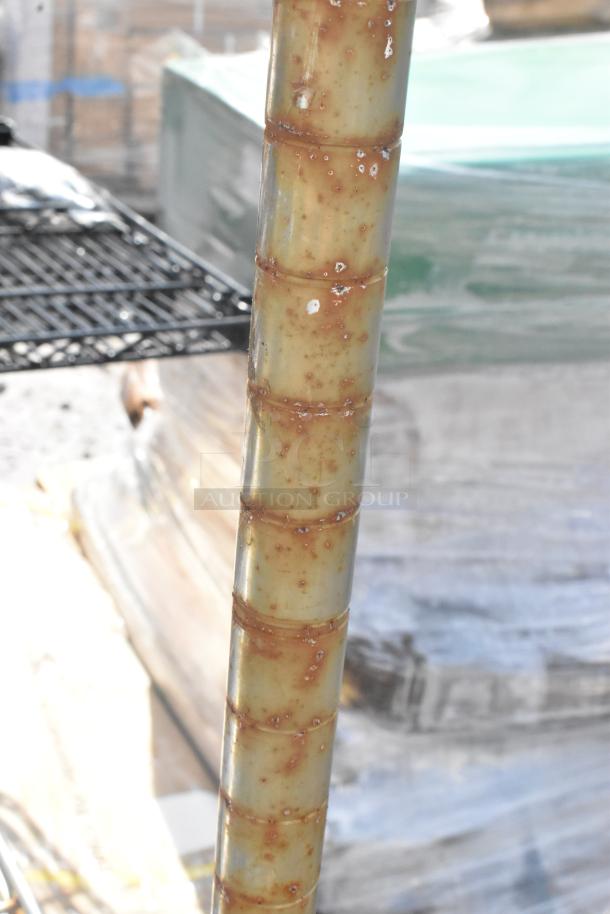 Chrome finish 4-tier wire shelving unit, visible rust on pole, buyer must dismantle, shipping not included.