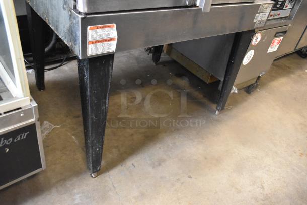 Hobart stainless steel commercial convection oven with view-through doors, metal oven racks, thermostatic controls, on metal legs.