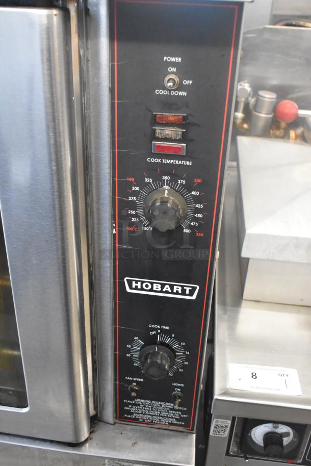 Hobart stainless steel commercial convection oven. Features view-through doors, metal racks, and thermostatic controls.