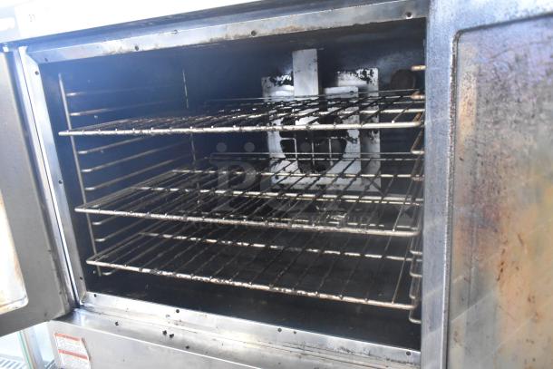 Hobart stainless steel commercial convection oven with view-through doors, metal racks, thermostatic controls, and metal legs.