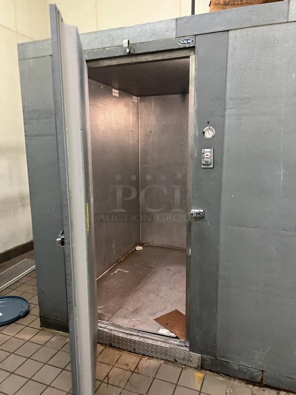 Norlake 8'x8'x7' self-contained walk-in freezer box with floor, Copeland compressor, Norlake CPF150DC condenser. Door ajar.