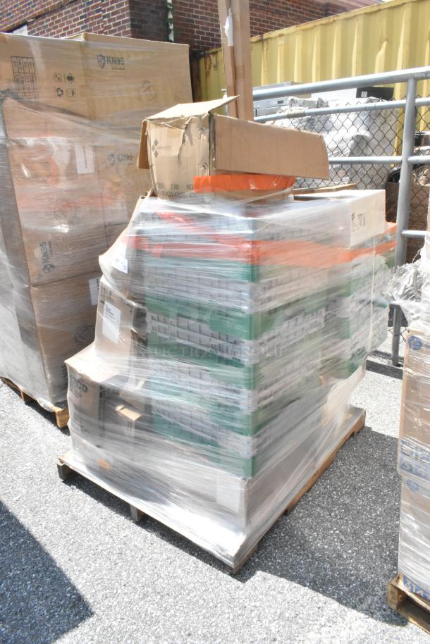 Pallet of assorted scratch and dent items, including glasses and plastic lids, wrapped in plastic. Some boxes show KN95 labeling.