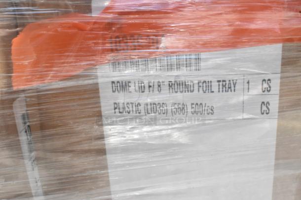 Bulk package of scratch and dent items including dome lids and trays. Label reads 500 plastic lids per case. Wrapped in plastic.