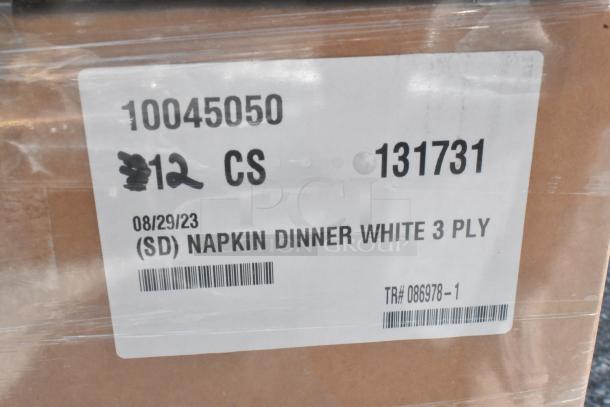 26 new scratch and dent boxes including napkins and platters. Label shows "Napkin Dinner White 3 Ply," dated 08/29/23.