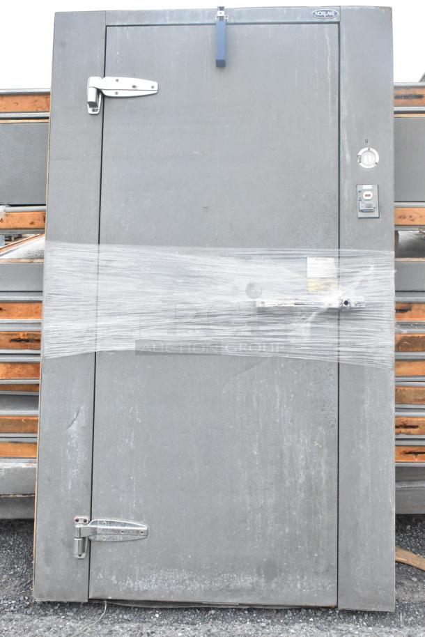 Norlake walk-in freezer door, wrapped for protection. Features handle and label. Includes Copeland compressor, Norlake condenser.