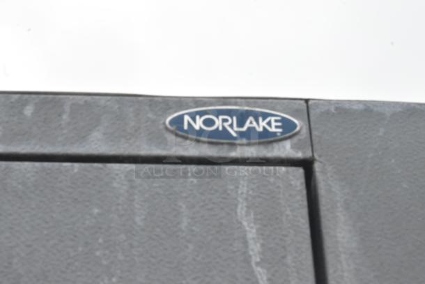 Norlake walk-in freezer detail showing brand label on gray textured surface, indicating its authenticity.