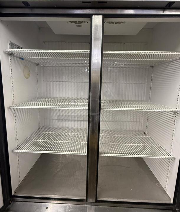 TRUE T-49F T Series two-section freezer with left/right hinge solid doors. Features multiple shelves, clean interior.