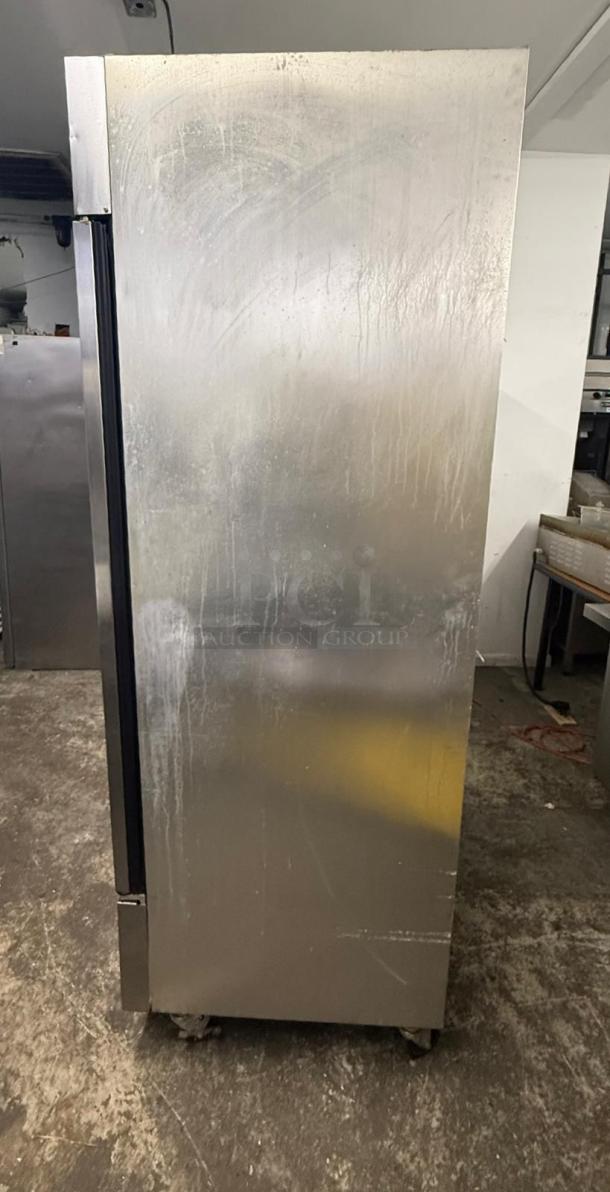 TRUE T-49F freezer, two-section, solid doors, stainless steel, left/right hinge. Appears used, visible wear and markings.