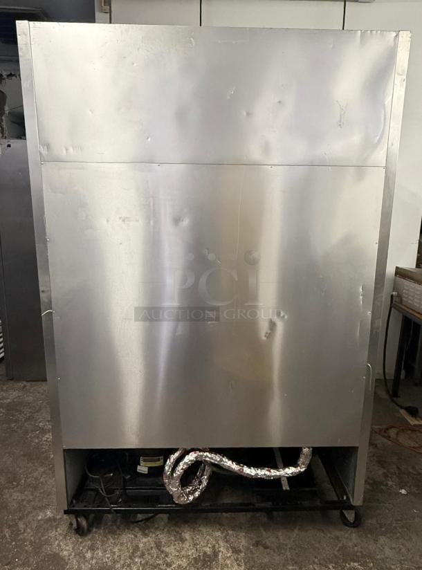 TRUE T-49F T Series Reach-In Freezer, two-section, solid doors. Visible wear, dents on surface, insulation wrapped at base.