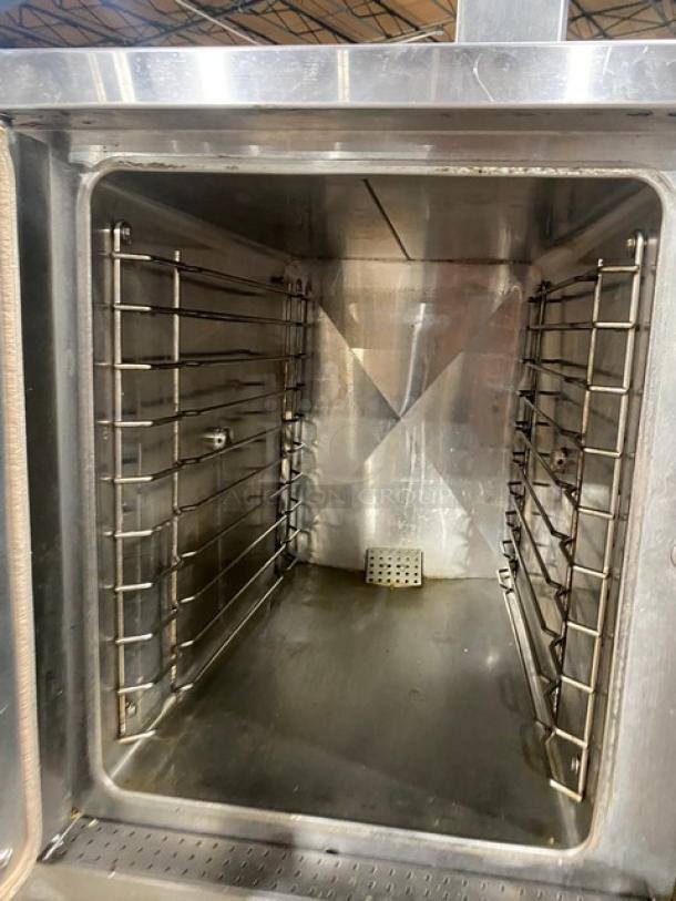 Vulcan stainless steel natural gas convection steamer with single undershelf stand, 120V 1 phase, on legs, in used condition.