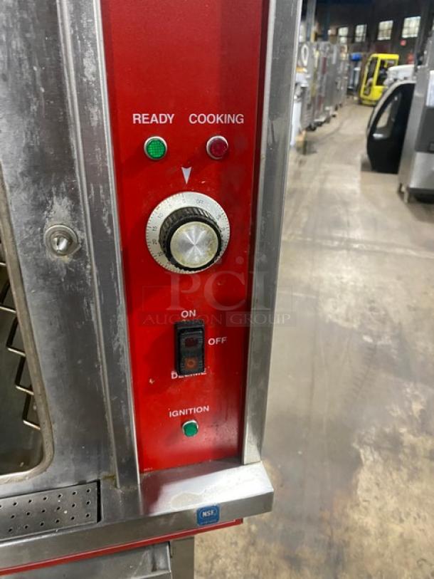 Vulcan stainless steel convection steamer, natural gas powered, with single undershelf stand. Features ready/cooking indicator, ignition switch, timer dial.