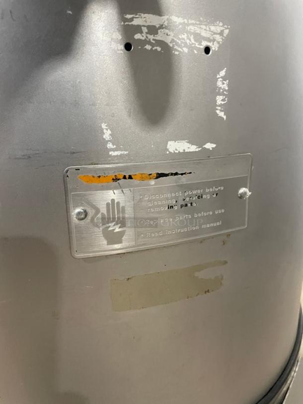 Hobart 6460C potato peeler, 60 lb. capacity, with stand and legs, visible wear, safety label instructing disconnect before servicing.