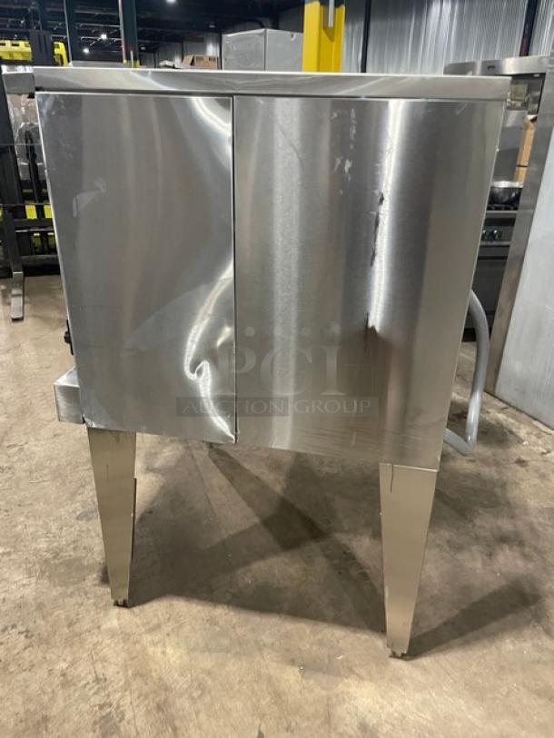 Stainless steel U.S. Range Summit Series convection oven, model SUME100, with thermostatic controls and wired racks, on legs.