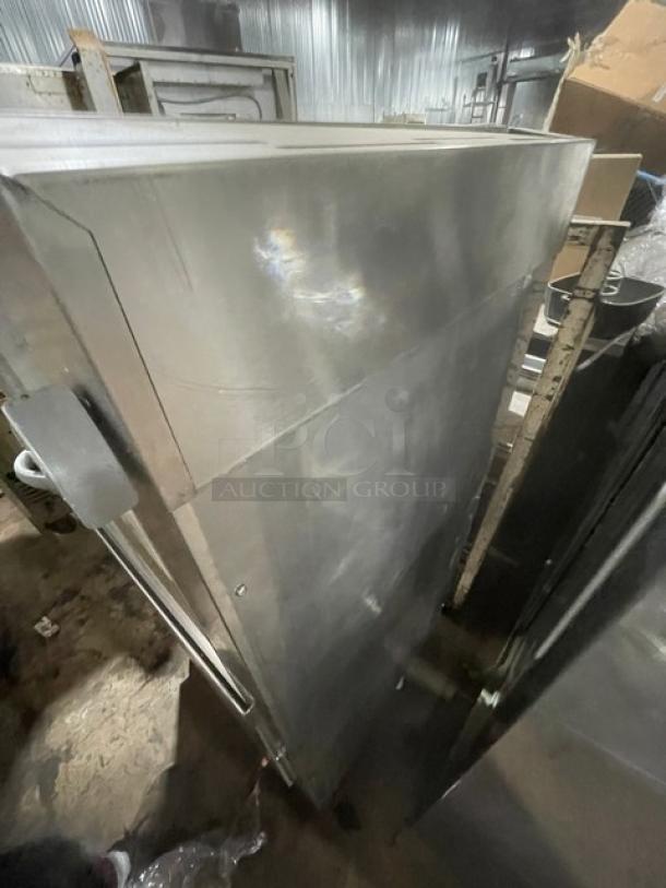 Winterhalter GS502 commercial stainless steel pass-through dishwasher with digital controls, electric-powered, on legs.