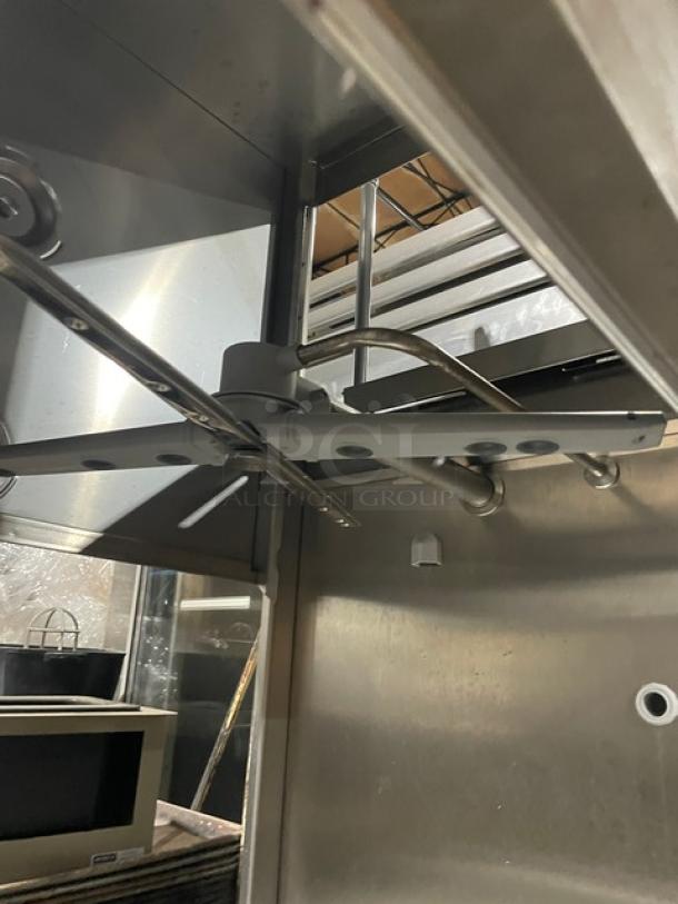 Winterhalter GS502 commercial pass-through dishwasher, stainless steel, electric, digital controls, 208V 1-phase, on legs.