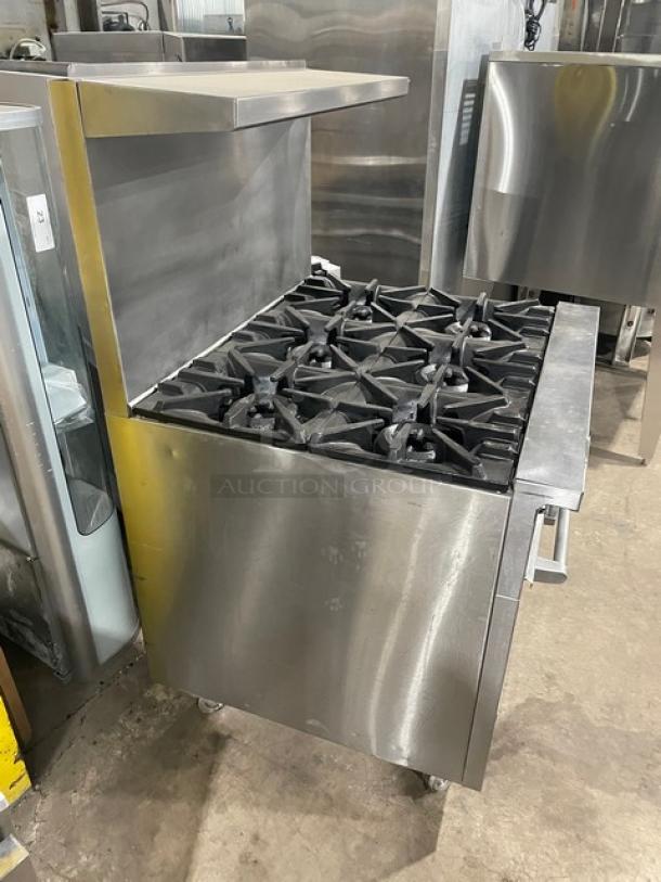SunFire stainless steel 6 burner range/oven combo with backsplash, overhead salamander shelf, and wired oven rack on casters.