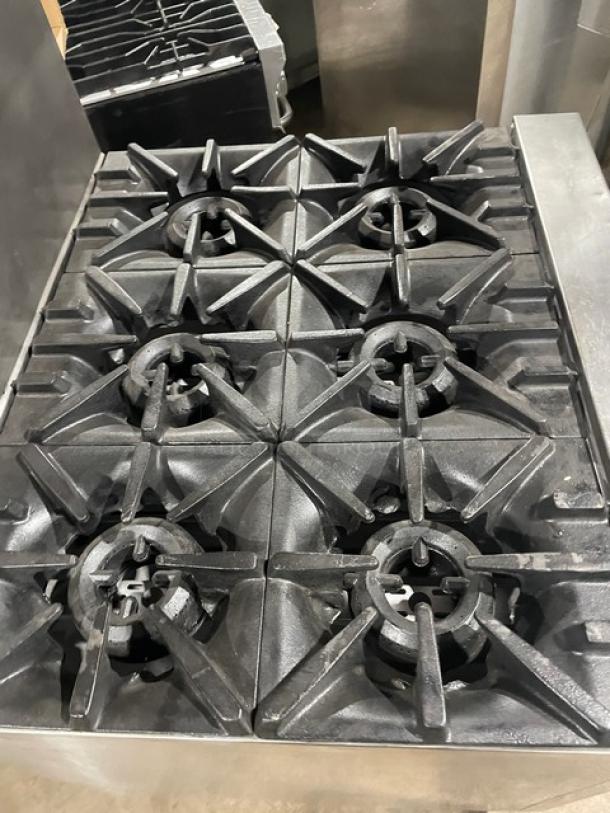 SunFire commercial stainless steel 6-burner gas range with backsplash, overhead salamander shelf, and wired oven rack.