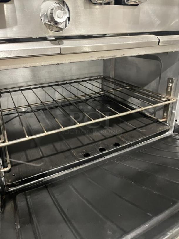 SunFire commercial stainless steel oven interior with a wired rack, part of a natural gas-powered 6 burner range/oven combo.