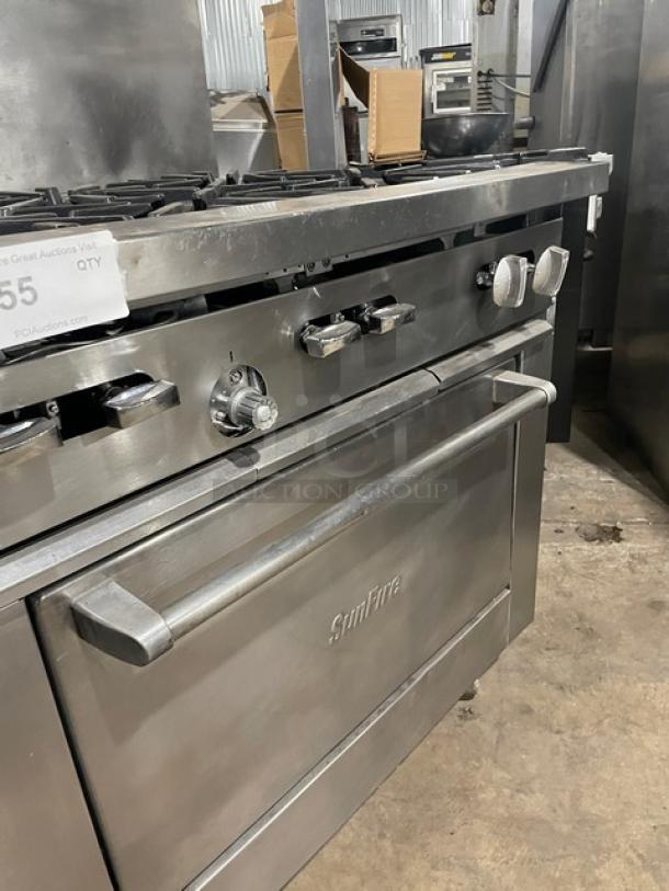SunFire commercial stainless steel 6 burner range/oven combo with back splash, overhead salamander shelf, and wired oven rack on casters.