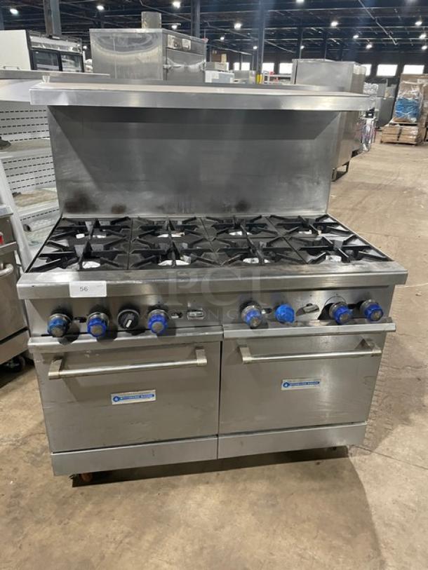 Standard Range stainless steel 8-burner gas range with double oven, backsplash, overhead salamander shelf, and wire rack on casters.