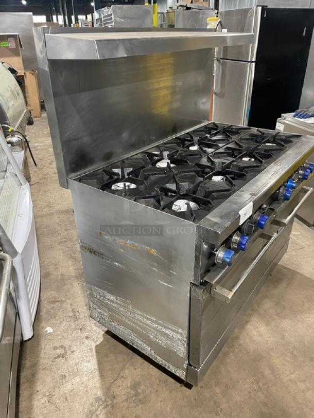 Standard Range stainless steel 8-burner natural gas range, double oven combo with backsplash, salamander shelf, and casters.