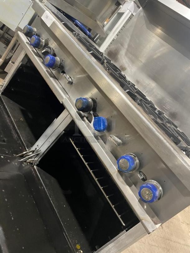 Standard Range commercial stainless steel 8-burner range/double oven combo with backsplash, salamander shelf, and wire rack.
