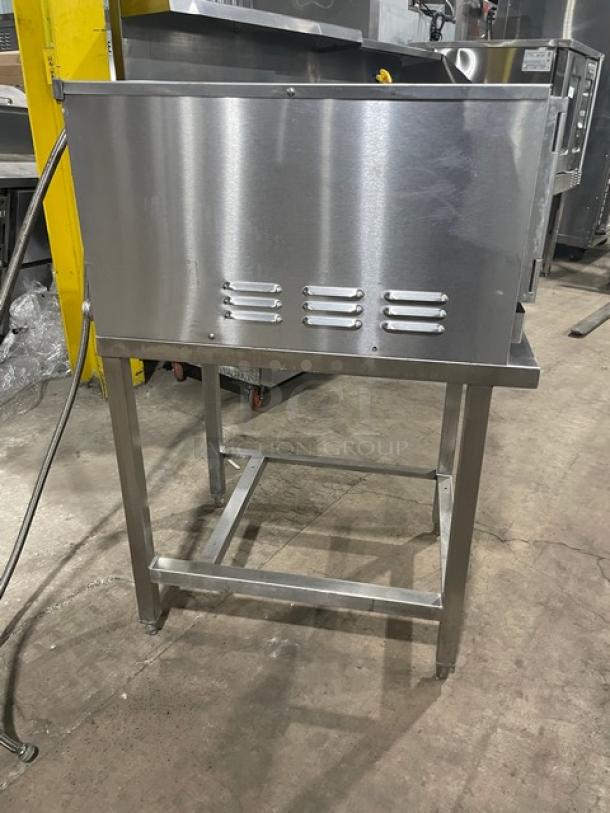 Groen HY-3E stainless steel convection steamer, electric-powered, with equipment stand and pan holding racks, model SN: 3E28241MS.
