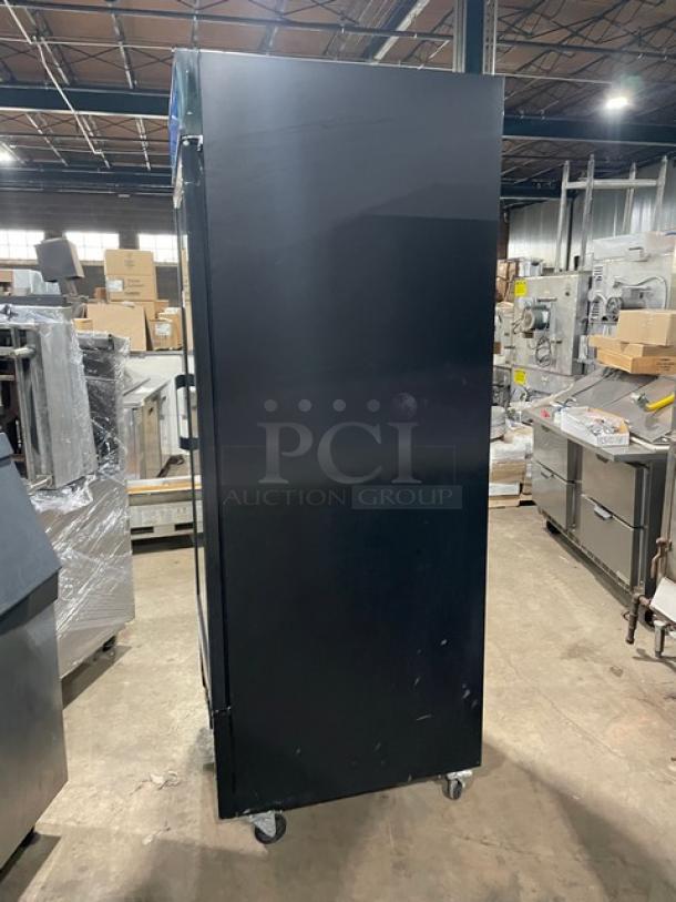 Avantco black single glass door merchandiser refrigerator, model 178GDC23HCB, with poly-coated wire racks, on casters.