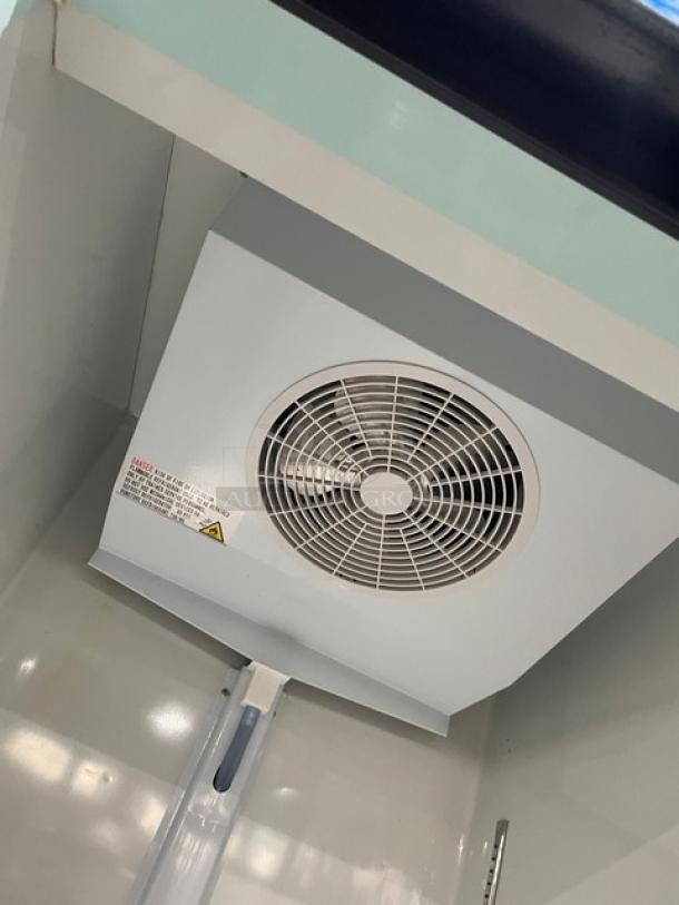 Avantco 178GDC23HCB merchandiser refrigerator interior, showing fan unit and white interior. Clean condition with visible wiring.