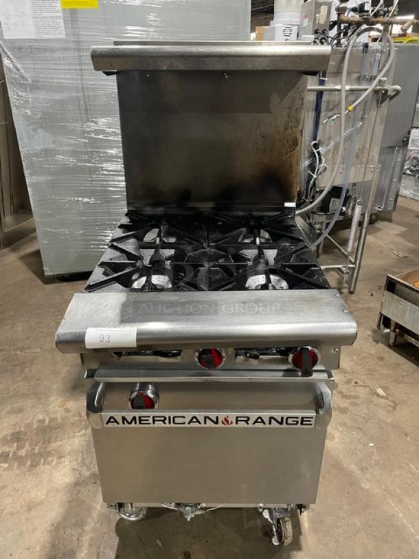 American Range commercial stainless steel 4-burner range/oven combo. Natural gas, with backsplash, salamander shelf, casters.