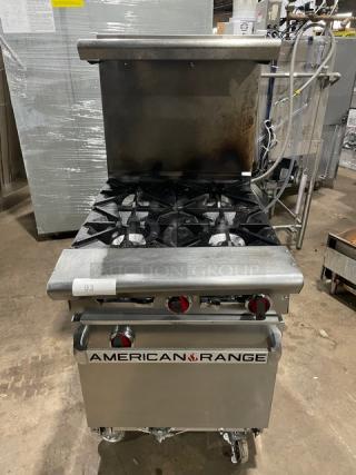 American Range commercial stainless steel 4-burner range/oven combo. Natural gas, with backsplash, salamander shelf, casters.
