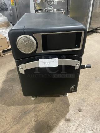 TurboChef NGO 2021 model black electric countertop rapid cook oven, ventless, with crank bar, Chipotle style, on legs.