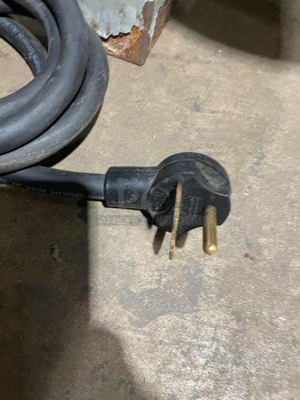 Close-up of TurboChef NGO model electric plug; shows 208/240V compatibility.