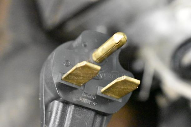 Close-up of a 3-prong plug for a 2018 Electrolux HSPP3RPRS Panini Press, 208V, 1 Phase, stainless steel model.
