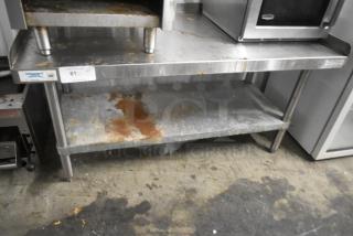 Regency 600ES2448G stainless steel equipment stand with metal undershelf, used, visible rust and wear, commercial use.