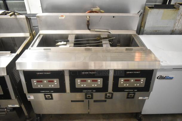 Henny Penny OFG-323 Stainless Steel Commercial Floor Style Natural Gas Powered 3 Bay Deep Fat Fryer w/ Filtration System on Commercial Casters. 255,000 BTU. - Image 1 of 14