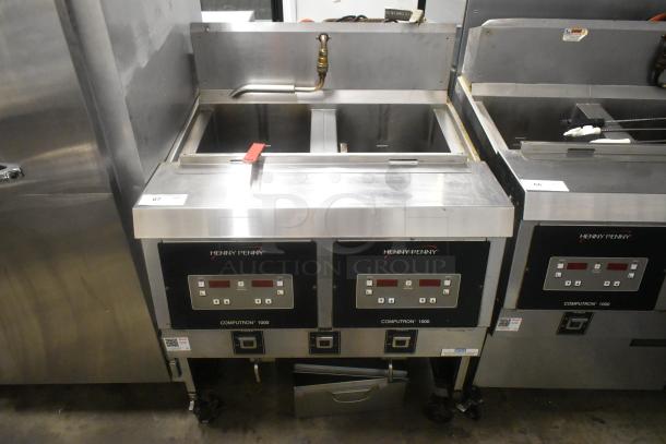 Henny Penny OFG-323 stainless steel 2-bay deep fat fryer on casters, 255,000 BTU, digital control panels, used condition.