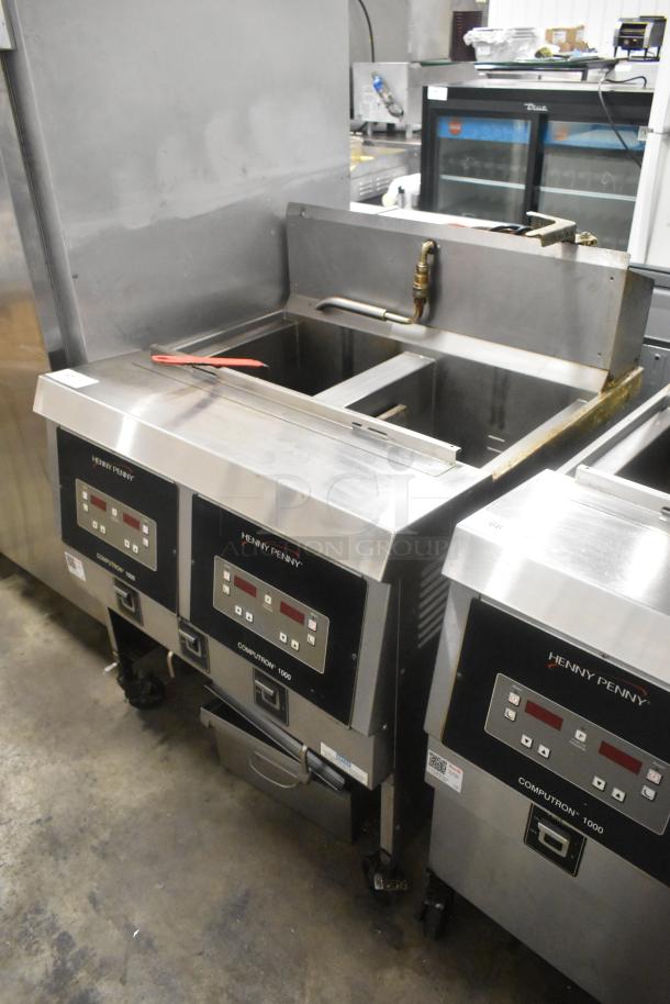 Henny Penny OFG-323 stainless steel commercial fryer, 2-bay, natural gas, 255,000 BTU, on casters, with control panel.